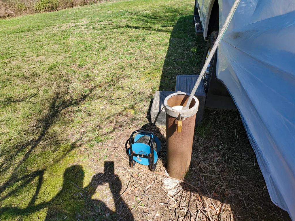 Environmental technician collecting water samples for groundwater monitoring and testing.